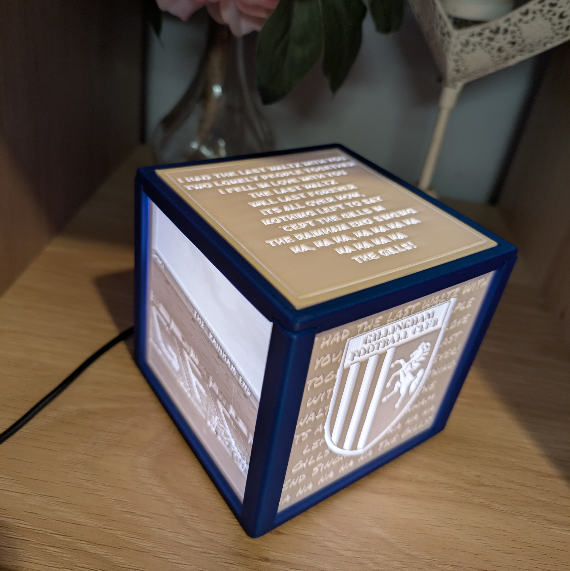 Blue framed lithophane light box with song lyrics on the top panel