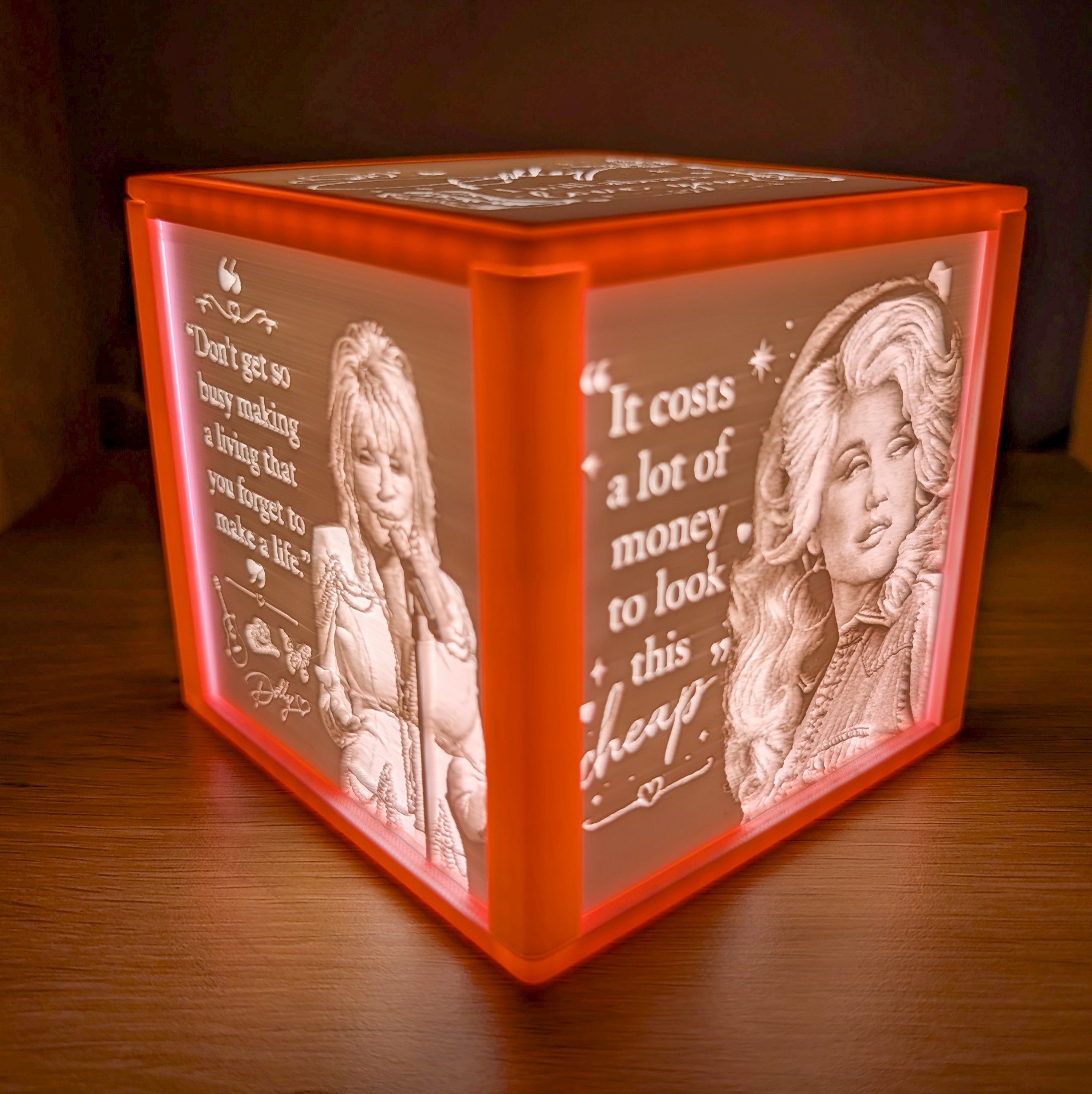 Red framed lithophane light box with portrait and quote panels glowing warmly